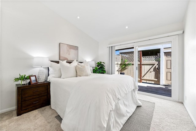 bedroom featuring access to exterior, light colored carpet, and lofted ceiling