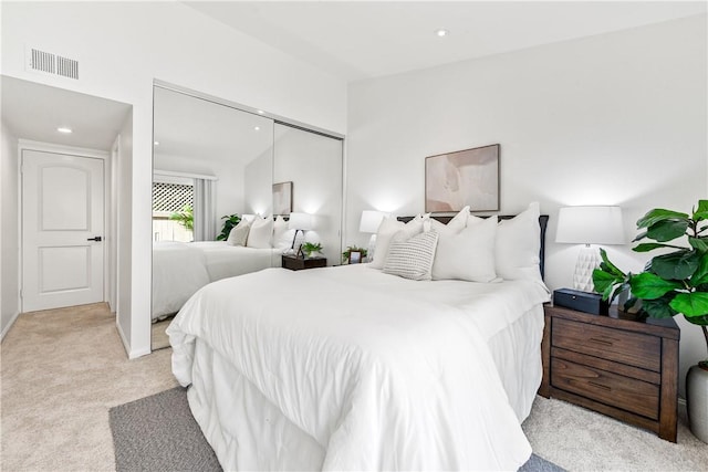 carpeted bedroom featuring a closet and lofted ceiling