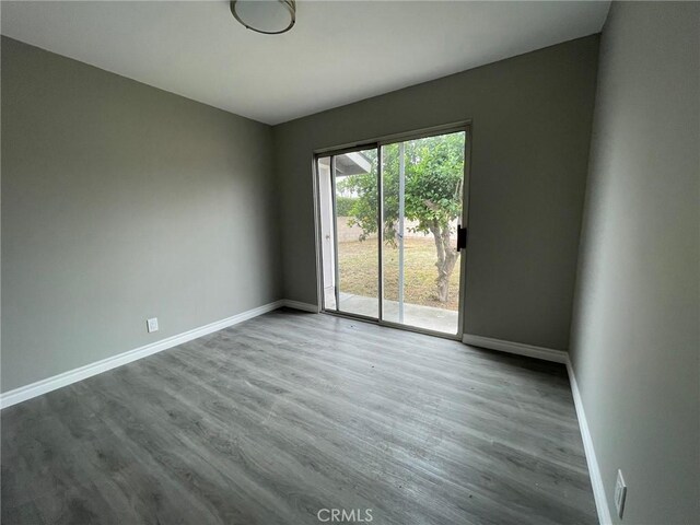 spare room with hardwood / wood-style floors