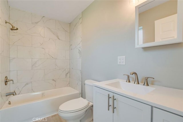 full bathroom with toilet, tiled shower / bath, and vanity