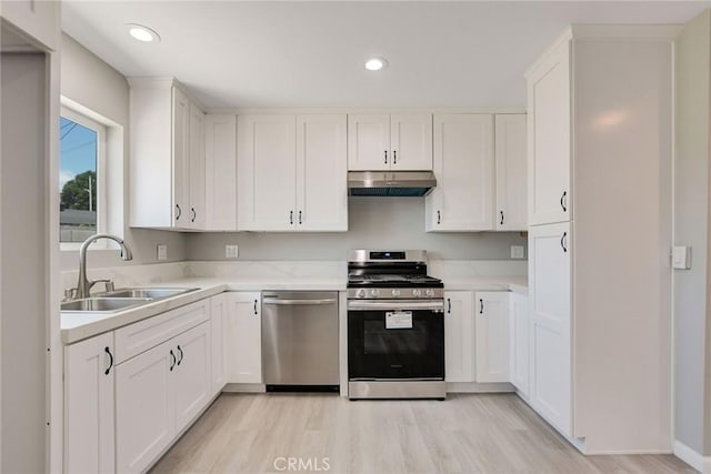 kitchen featuring appliances with stainless steel finishes, white cabinets, and sink