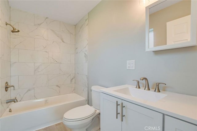 full bathroom with toilet, tiled shower / bath, and vanity