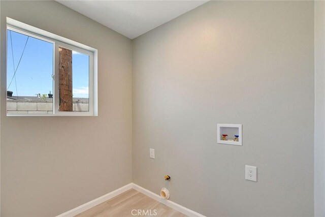 laundry room featuring washer hookup and light hardwood / wood-style floors