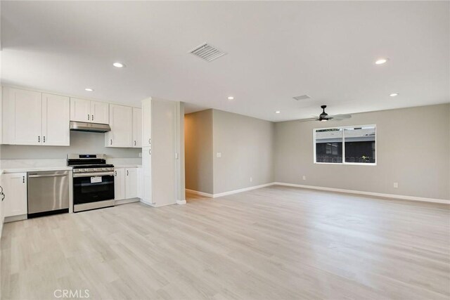 kitchen with ceiling fan, white cabinetry, stainless steel appliances, and light wood-type flooring