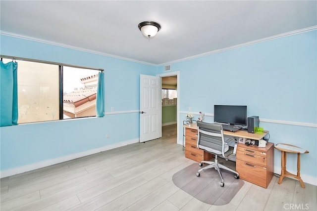 office area featuring light wood-style floors, visible vents, baseboards, and crown molding