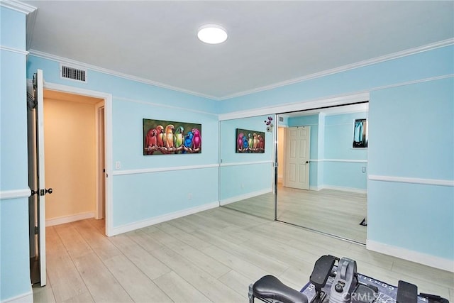 interior space featuring crown molding and hardwood / wood-style floors