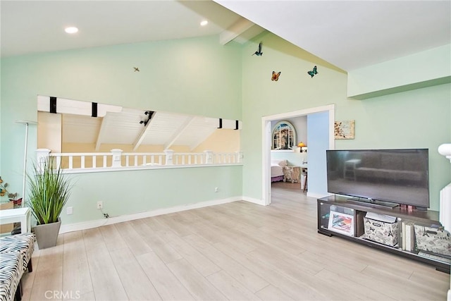 living room with light wood-style floors, recessed lighting, lofted ceiling with beams, and baseboards