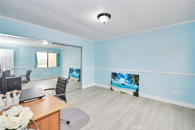 home office featuring ornamental molding and light hardwood / wood-style flooring