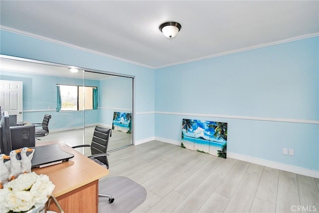 home office featuring baseboards, light wood-type flooring, and crown molding