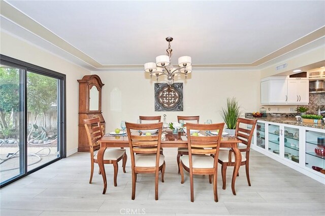 dining area featuring a notable chandelier and light hardwood / wood-style flooring