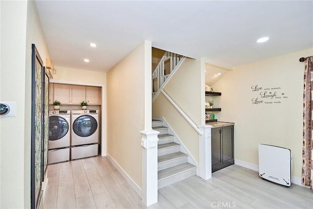 laundry room with light wood finished floors, separate washer and dryer, cabinet space, and recessed lighting