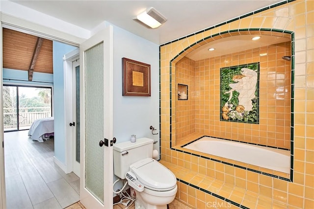 bathroom with tiled bath and toilet