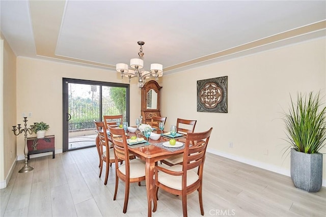 dining area featuring light hardwood / wood-style flooring and a chandelier