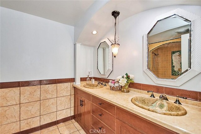 bathroom featuring vanity, tile patterned floors, and tile walls