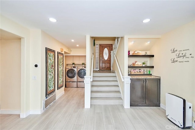 staircase with hardwood / wood-style floors and washer and clothes dryer