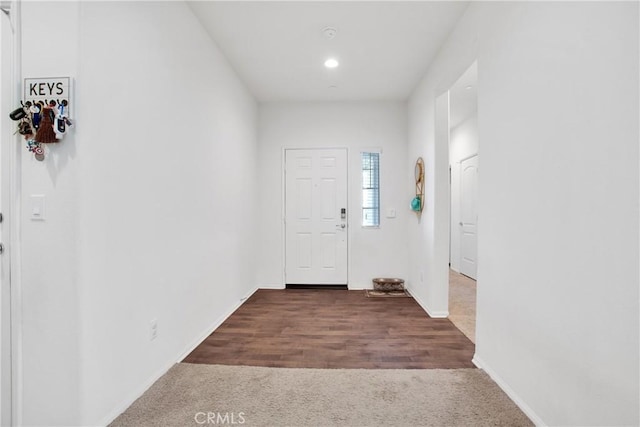 foyer entrance with dark colored carpet