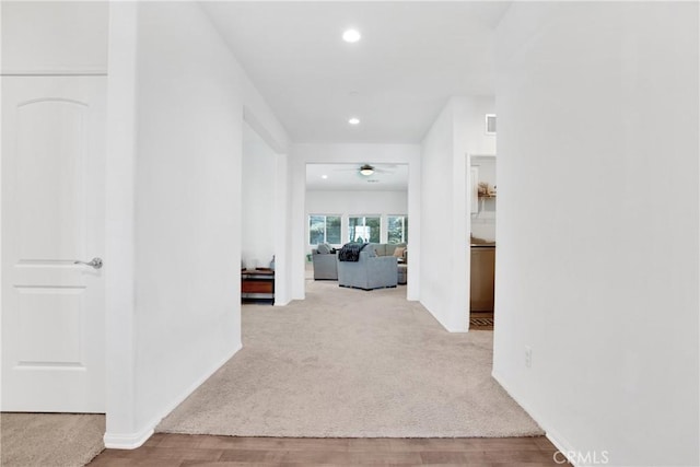 hallway featuring light carpet