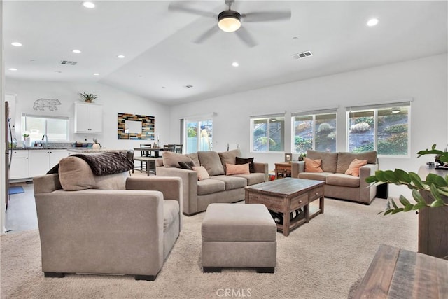 living room featuring ceiling fan, sink, light carpet, and lofted ceiling