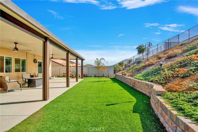 view of yard featuring ceiling fan and a patio area