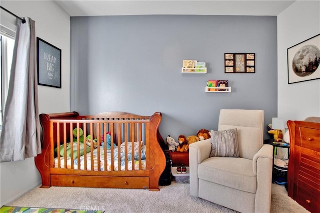 carpeted bedroom featuring a crib