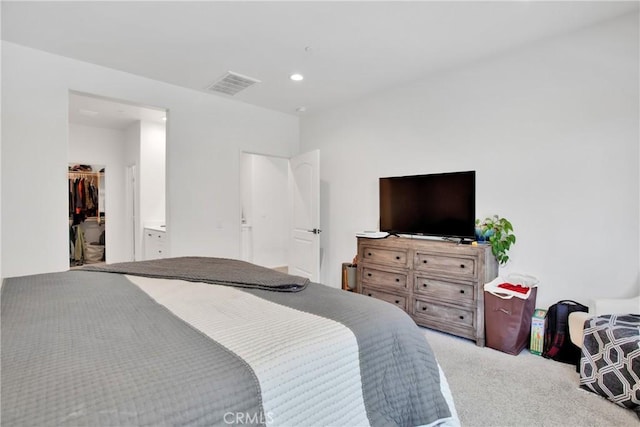 bedroom with carpet, a closet, and a spacious closet