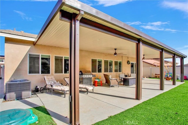 back of property featuring ceiling fan, a patio, and central AC