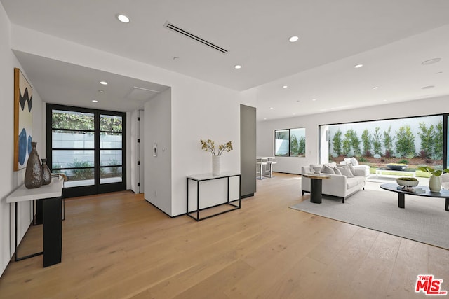 living room featuring plenty of natural light and light hardwood / wood-style flooring