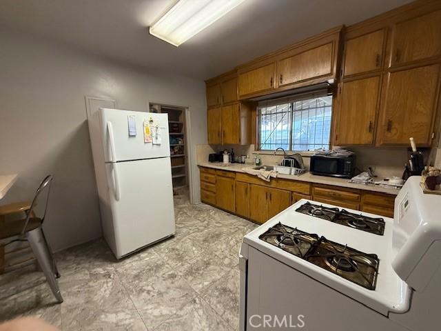 kitchen with sink and white appliances