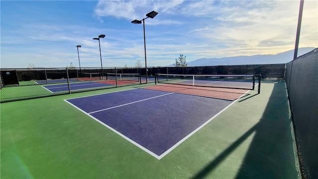 view of tennis court with a mountain view