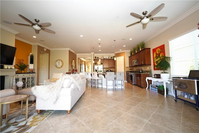 living room featuring ceiling fan, light tile patterned floors, and ornamental molding