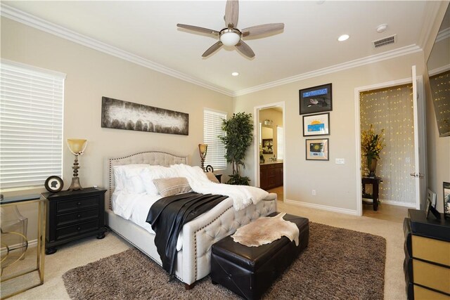 bedroom featuring ceiling fan, light carpet, ensuite bathroom, and ornamental molding