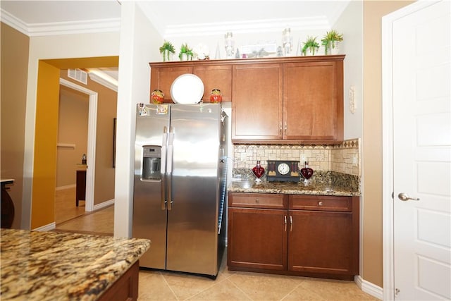 kitchen featuring stainless steel fridge with ice dispenser, light tile patterned flooring, ornamental molding, and stone countertops