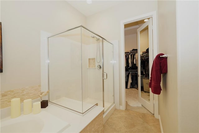 bathroom with tile patterned flooring and walk in shower