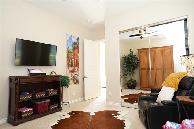 living room with ceiling fan and light colored carpet