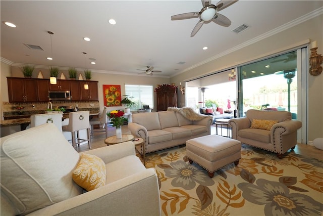 living room featuring ceiling fan and ornamental molding