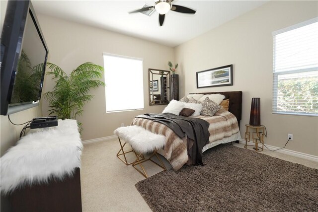 bedroom featuring ceiling fan and light carpet