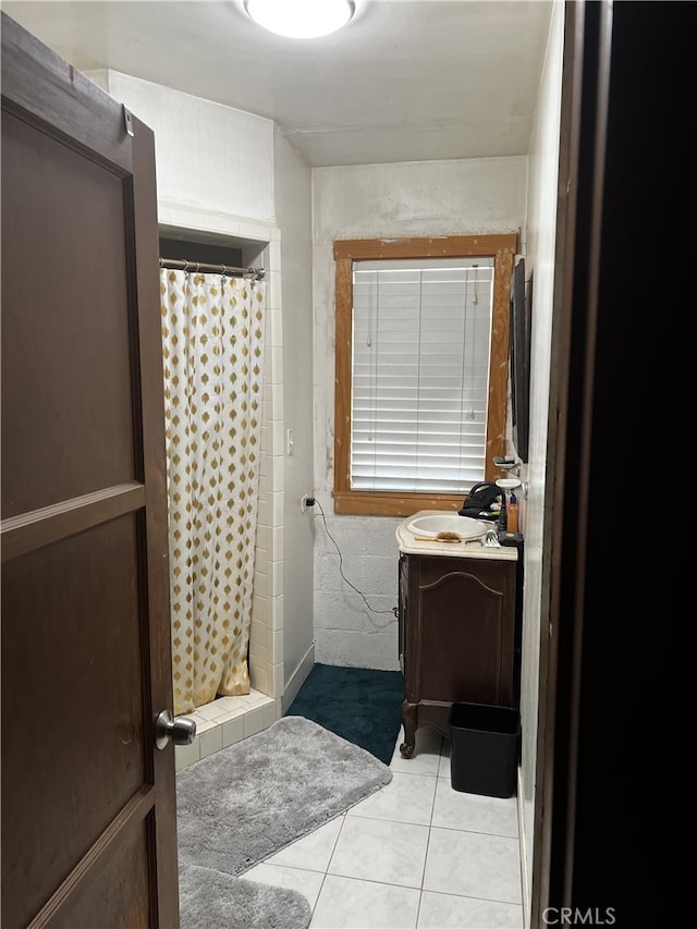 bathroom featuring tile patterned floors, walk in shower, and sink