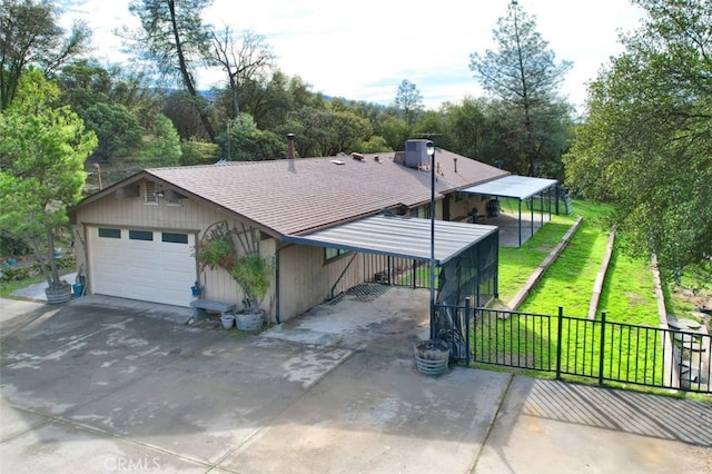 view of front of house featuring a garage, a front yard, and a carport