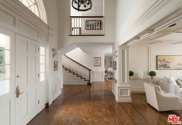 entrance foyer featuring a high ceiling and decorative columns