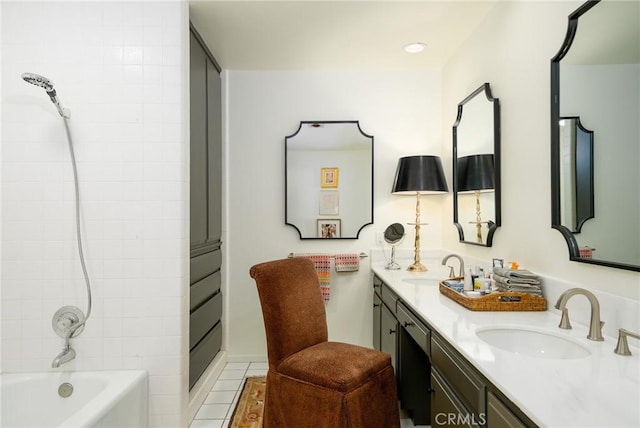 bathroom with tile patterned flooring, bathing tub / shower combination, and vanity