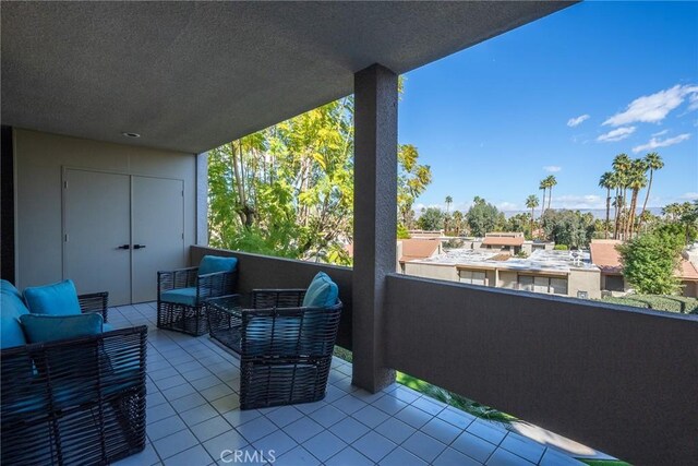 view of patio featuring an outdoor hangout area and a balcony