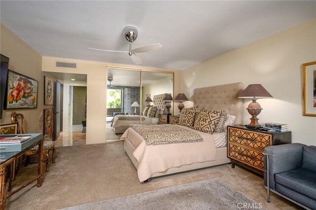 bedroom with ceiling fan, carpet, and a closet