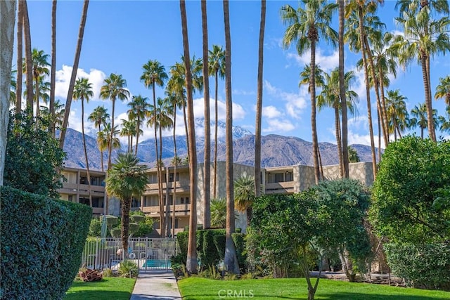 exterior space featuring a mountain view and a lawn