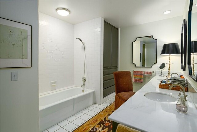 bathroom with tile patterned floors, tiled shower / bath, and vanity