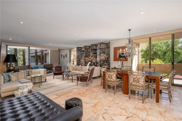 dining space featuring an inviting chandelier and a wall of windows