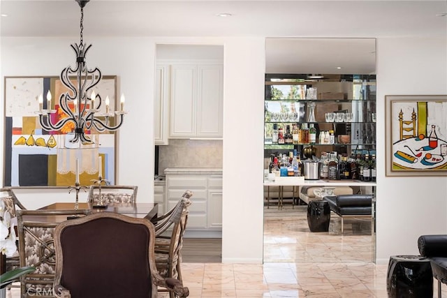 dining area featuring bar area and an inviting chandelier