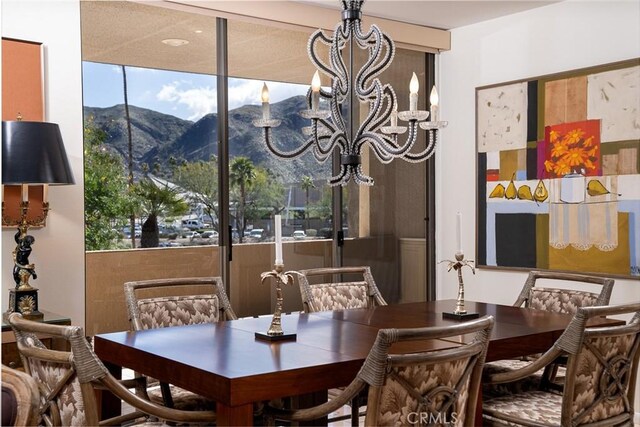 dining area with a mountain view and a chandelier