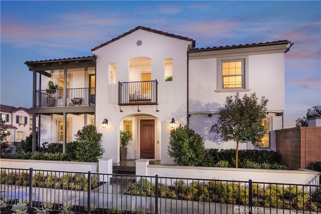 mediterranean / spanish home featuring a balcony