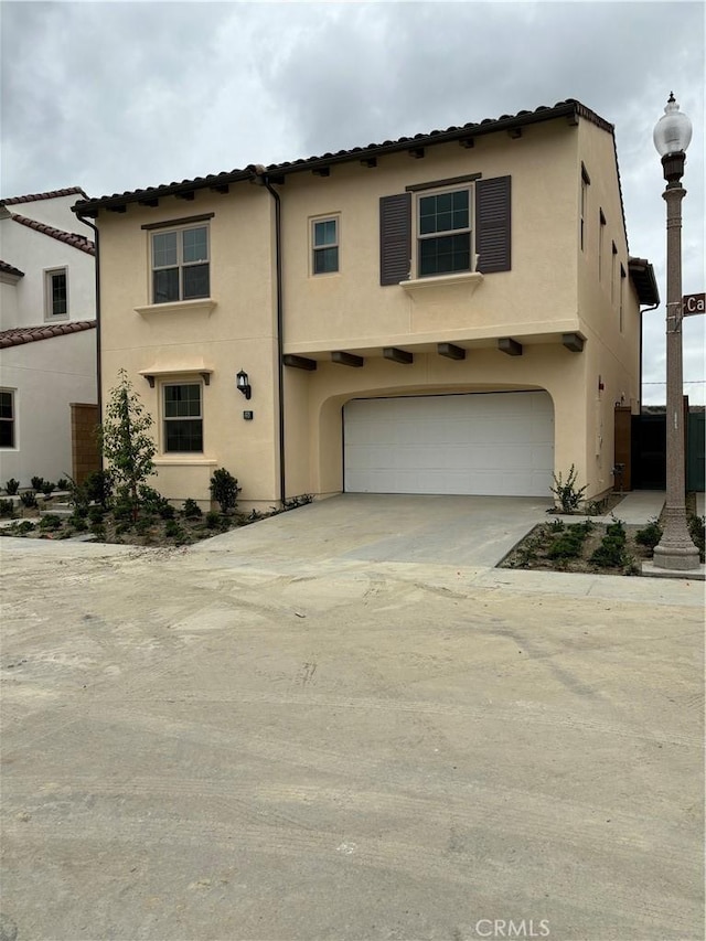 mediterranean / spanish home with a garage