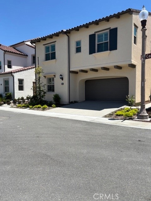 250 Canterbury, Irvine, CA 92618 - view of front facade featuring stucco siding, an attached garage, a tile roof, and driveway